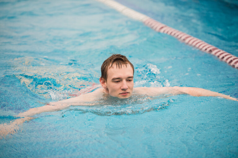 man swims using the crawl stroke in indoor pool 2024 11 03 00 46 49 utc